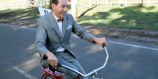 Paul Reubens as Pee-wee herman on a bike in the Pee-wee movie