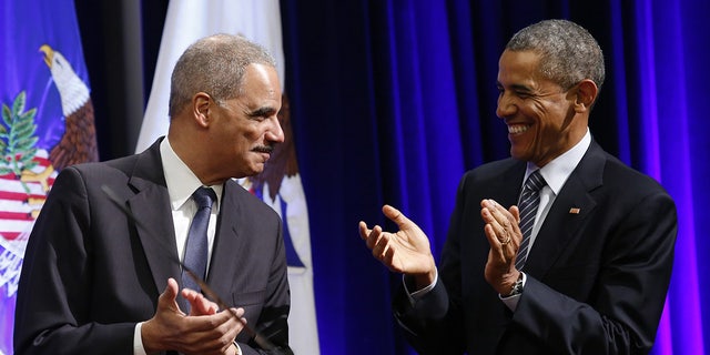 Obama and Eric Holder laugh together