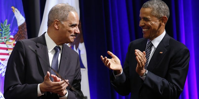 Obama and Eric Holder laugh together