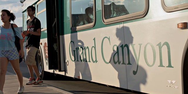 Guests exit a shuttle bus at Grand Canyon