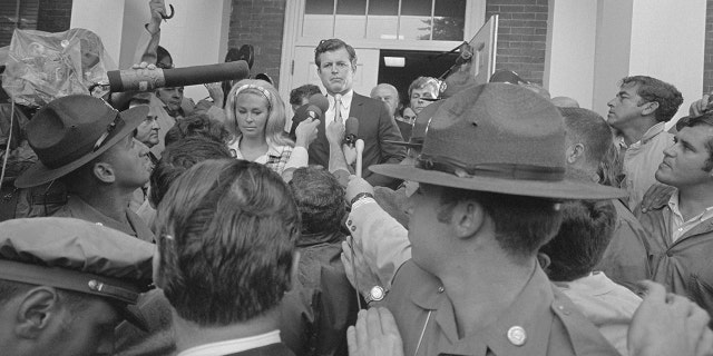 Sen. Ted Kennedy outside of a court house surrounded by reporters