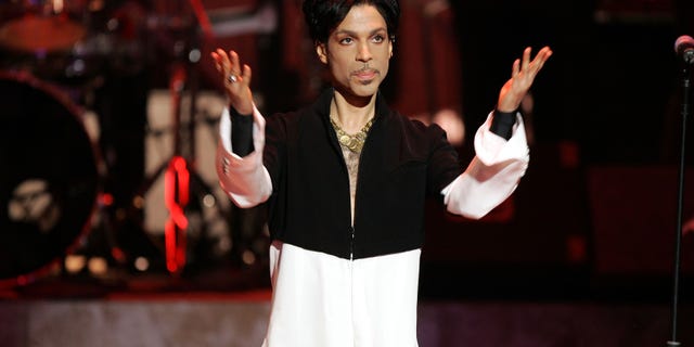 Prince on stage with arms out