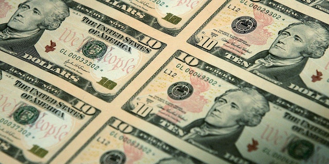An uncut sheet of many $10 bills