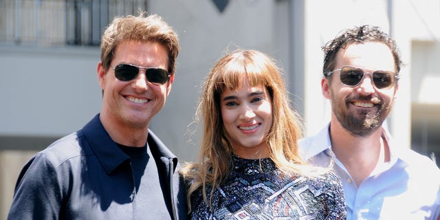 Tom Cruise posing with Sofia Boutella and Jake Johnson