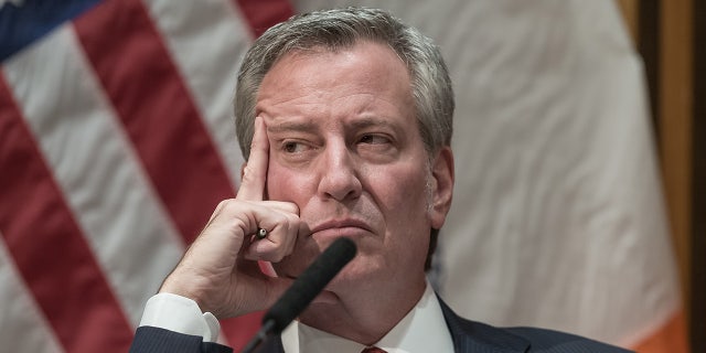 Then-NYC Mayor De Blasio looking pensive during a press conference at NYPD headquarters