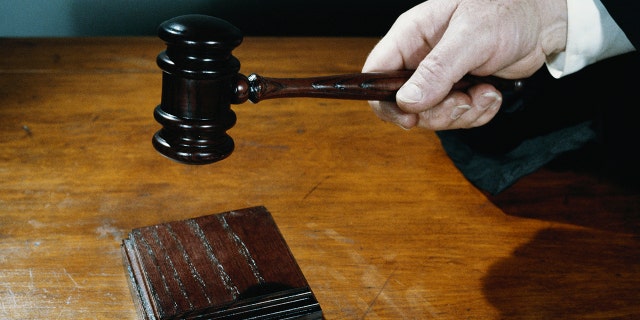 hand holding gavel stock image