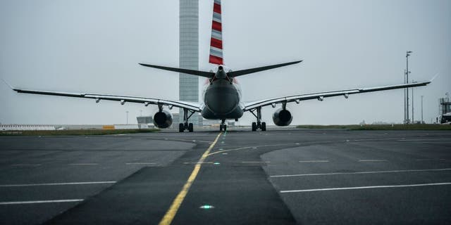 plane on runway of Charles de Gaulle Airport
