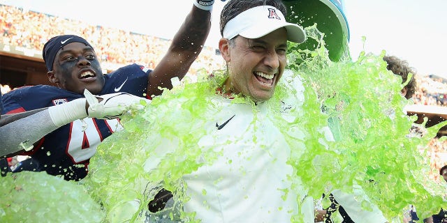 Jedd Fisch celebrates after beating ASU