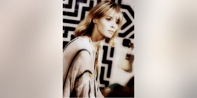 Anita Pallenberg wearing a white and black dress