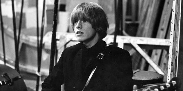 A close-up of Brian Jones playing the guitar