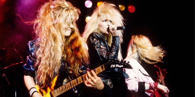 A close-up of Vixen huddled together and performing on stage