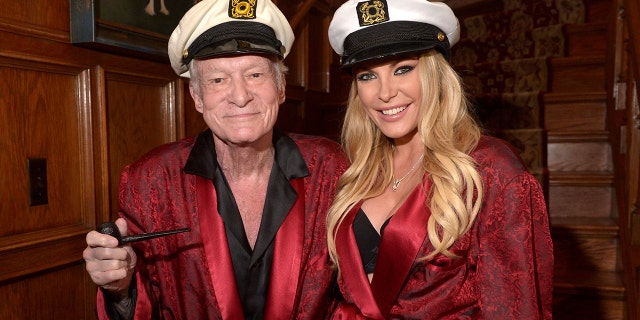 Hugh Hefner and Crystal Hefner wearing matching robes