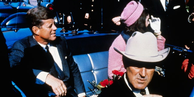 JFK and Jackie Kennedy sitting next to each other in Texas before the president was assassinated