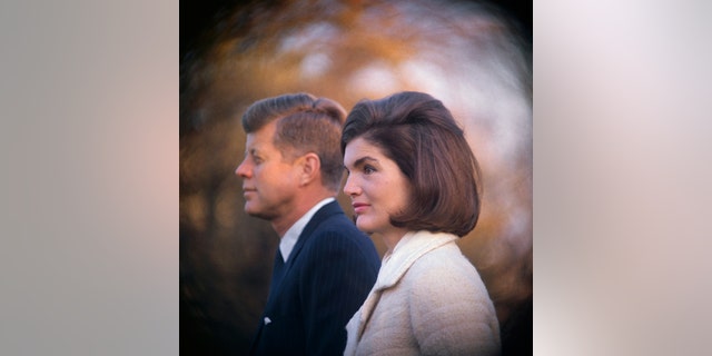 A close-up of President JFK and Jackie Kennedy looking away from the camera wearing formal attire