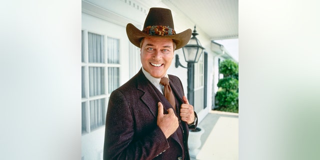 Larry Hagman dressed as JR in a smiling photo