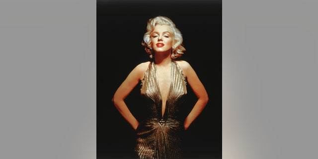 Marilyn Monroe wearing a low-cut gold gown