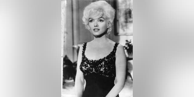 Marilyn Monro wearing a black lace dress