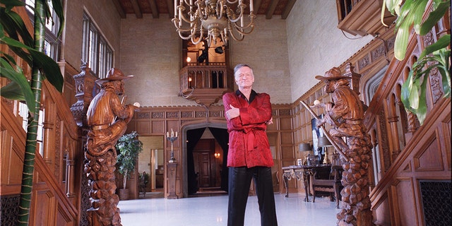 Hugh Hefner wearing his red robe at the Playboy Mansion