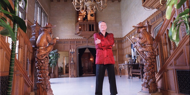 Hugh Hefner wearing his red robe at the Playboy Mansion