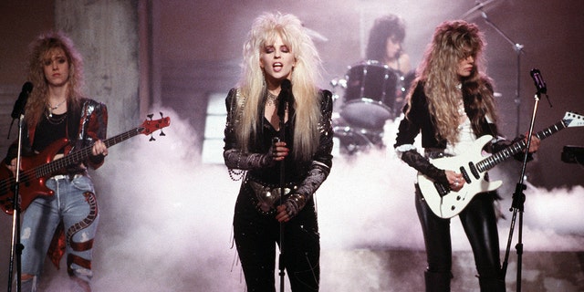 A screenshot of Vixen performing against smoke in a music video