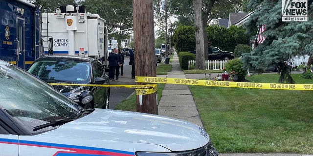 Suffolk County police stationed outside of a home in Massapequa Park