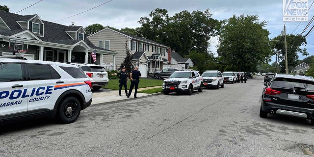 Suffolk County police stationed outside of a home