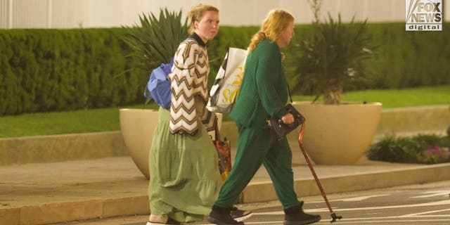 Rex Heuermann's wife, Asa Ellerup and daughter, Victoria Heuermann walk on the street