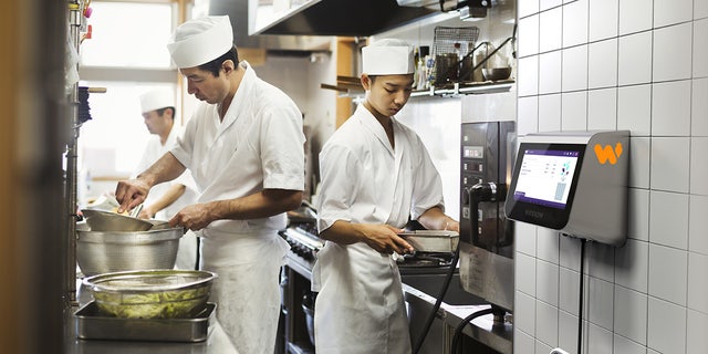 chefs at a sushi restaurant