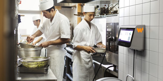 chefs at a sushi restaurant