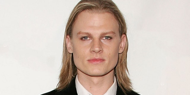 Jeffrey Carlson wears black suit and tie to movie premiere