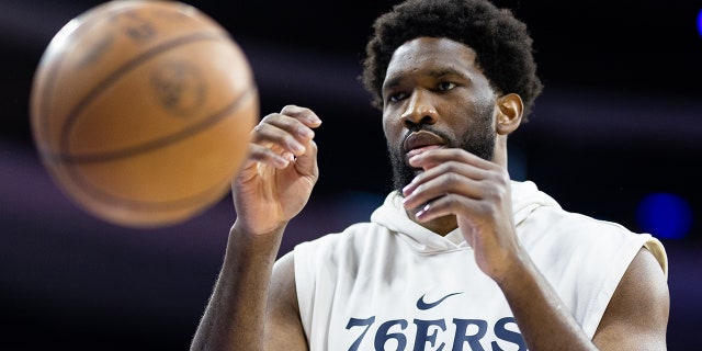Joel Embiid warms up