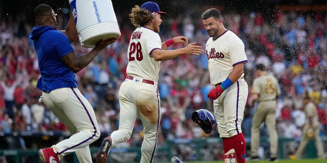 Kyle Schwarber celebrates with Alec Bohm