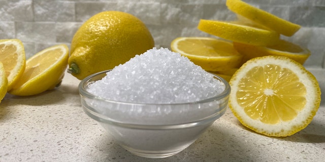 Close up view of salt bowl and sliced lemons.