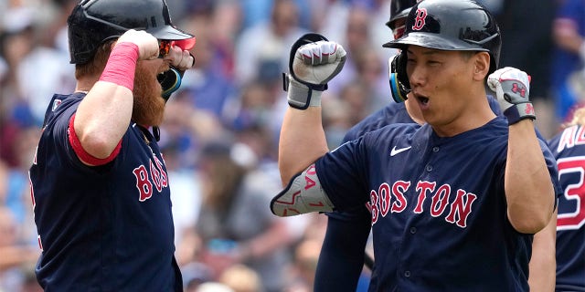 Masataka Yoshida celebrates with Justin Turner