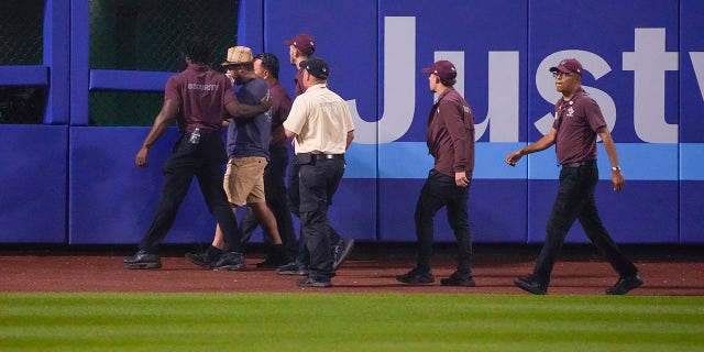 Security escorts a fan