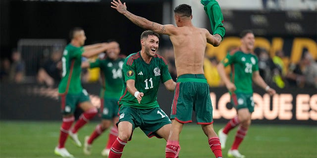 Santiago Giménez celebrates with teammate