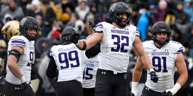 Northwestern football players celebrate play