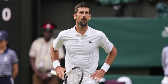 Novak Djokovic with his hands on his hips