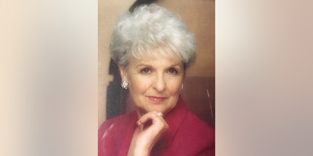 A portrait of Loretta Bowersock wearing a burgundy dress