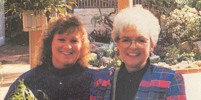 Terri Bowersock and her mother Loretta Bowersock smiling and posing in colorful sweaters