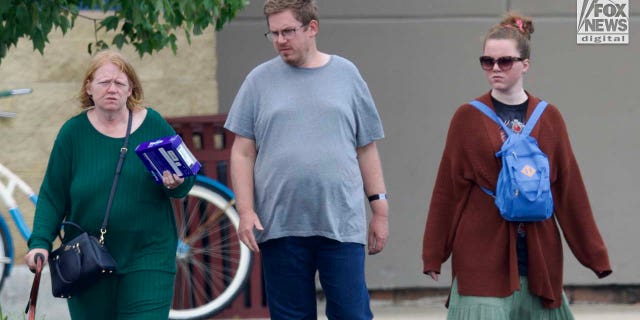 Rex Heuermann's wife, Asa Ellerup and daughter, Victoria Heuermann walk on the street