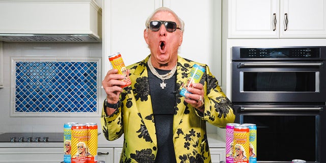 Ric Flair poses with energy drinks