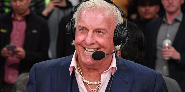 Ric Flair smiles with headset on