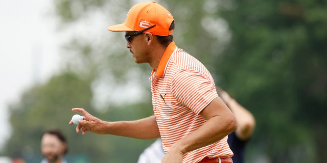 Rickie Fowler looks on