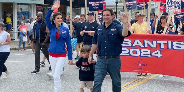 Florida Governor and presidential candidate Ron DeSantis walks alongside supporters