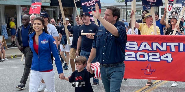 Florida Governor and presidential candidate Ron DeSantis walks alongside supporters