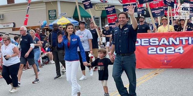 Florida Governor and presidential candidate Ron DeSantis walks alongside supporters