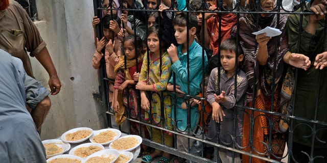 Women and children wait for food