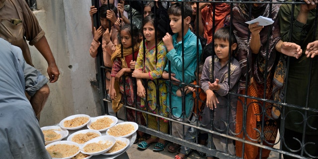 Women and children wait for food