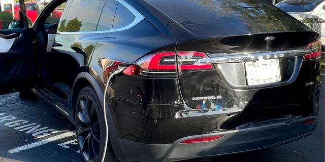 Tesla plugged into charging station, double parked in Vallejo CA